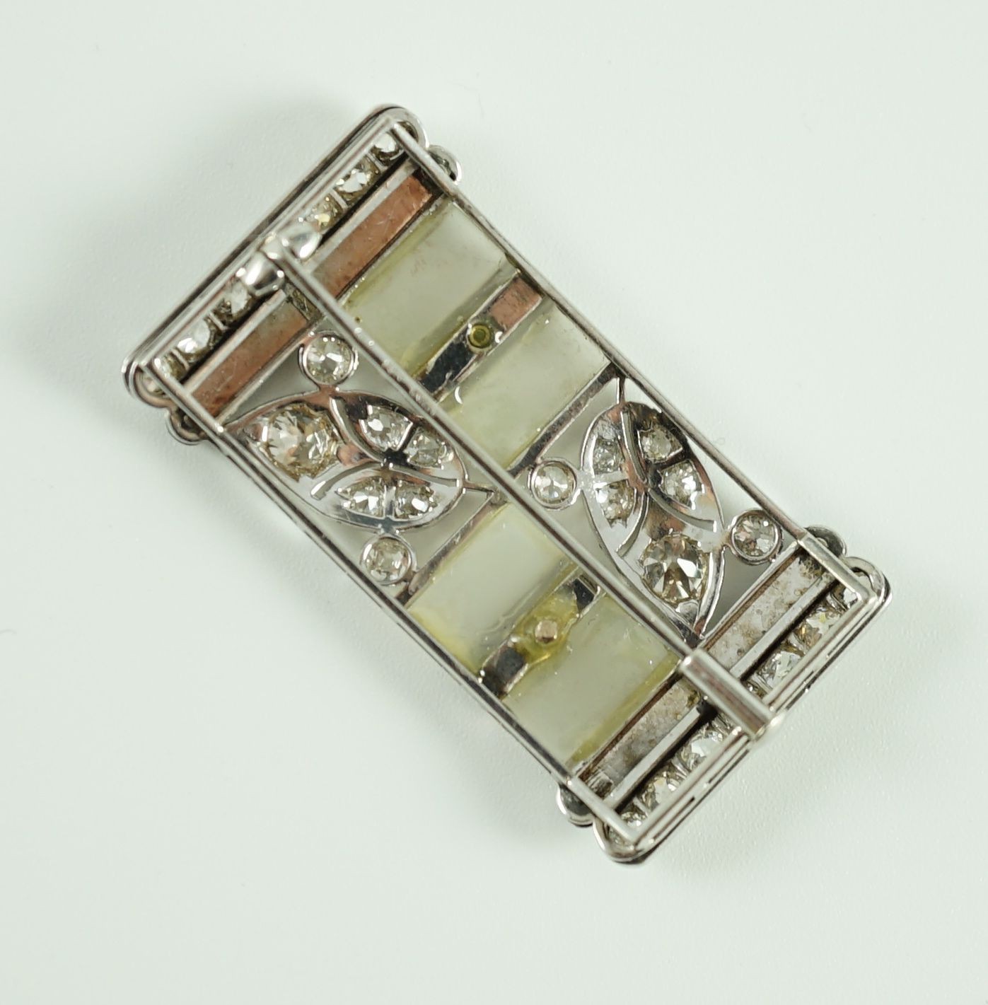 A 1930's/1940's Austro-Hungarian white gold, millegrain set diamond, frosted glass and black enamel rectangular brooch